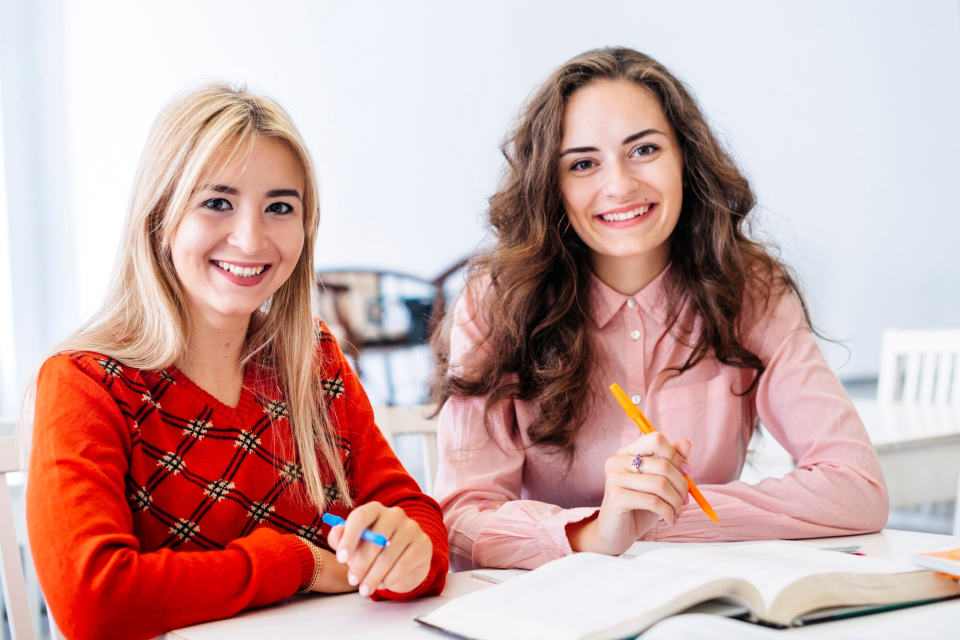 Smiling-women-studying-in-library
